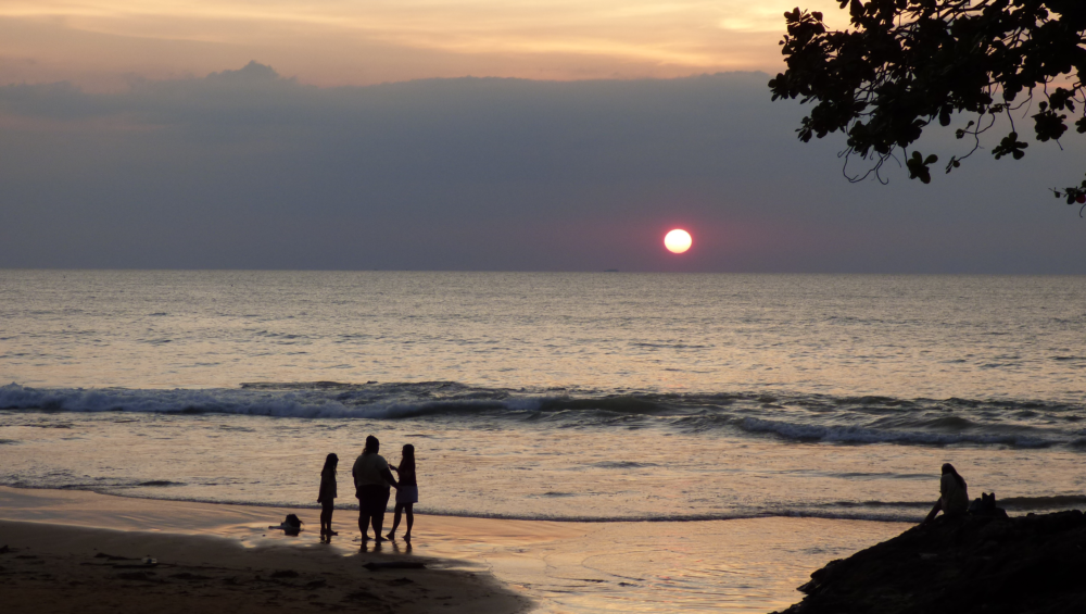 A family enjoying the sunset at Nang Thong beach Khao lak, Thailand